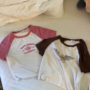 These are two garage baby tees. Brown is XS and Pink is S